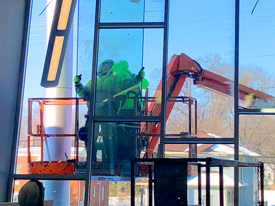 Our guys installing the glass into custom angled window framing 